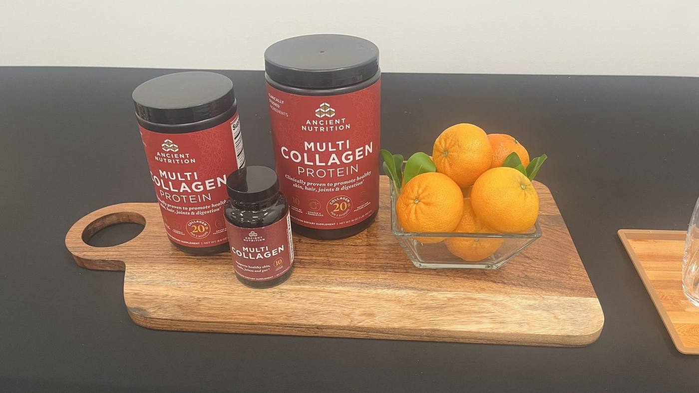Multi Collagen products on a wood board with oranges