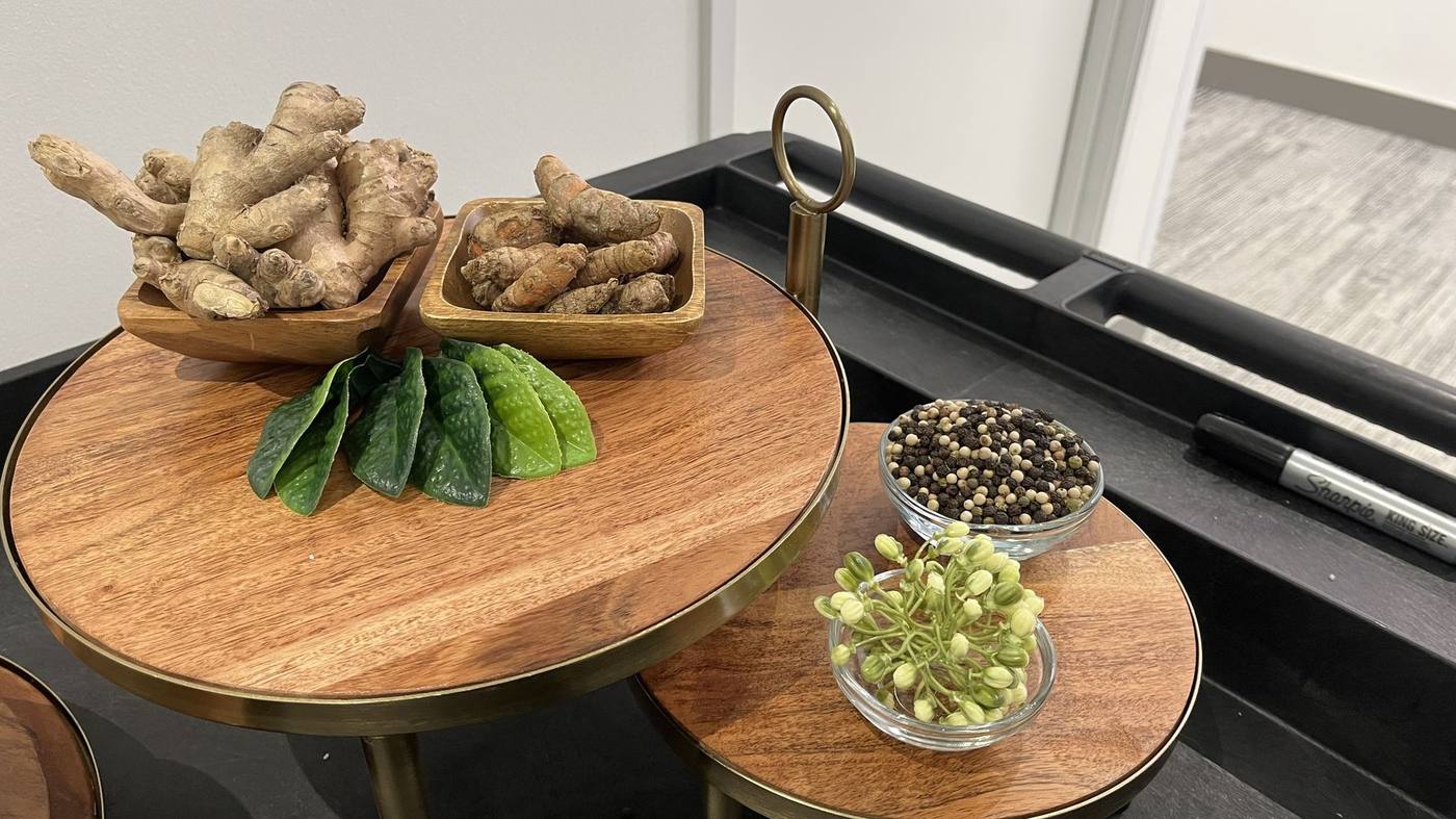 Styled tiered trays — ginger, turmeric, peppercorn and fresh leaves