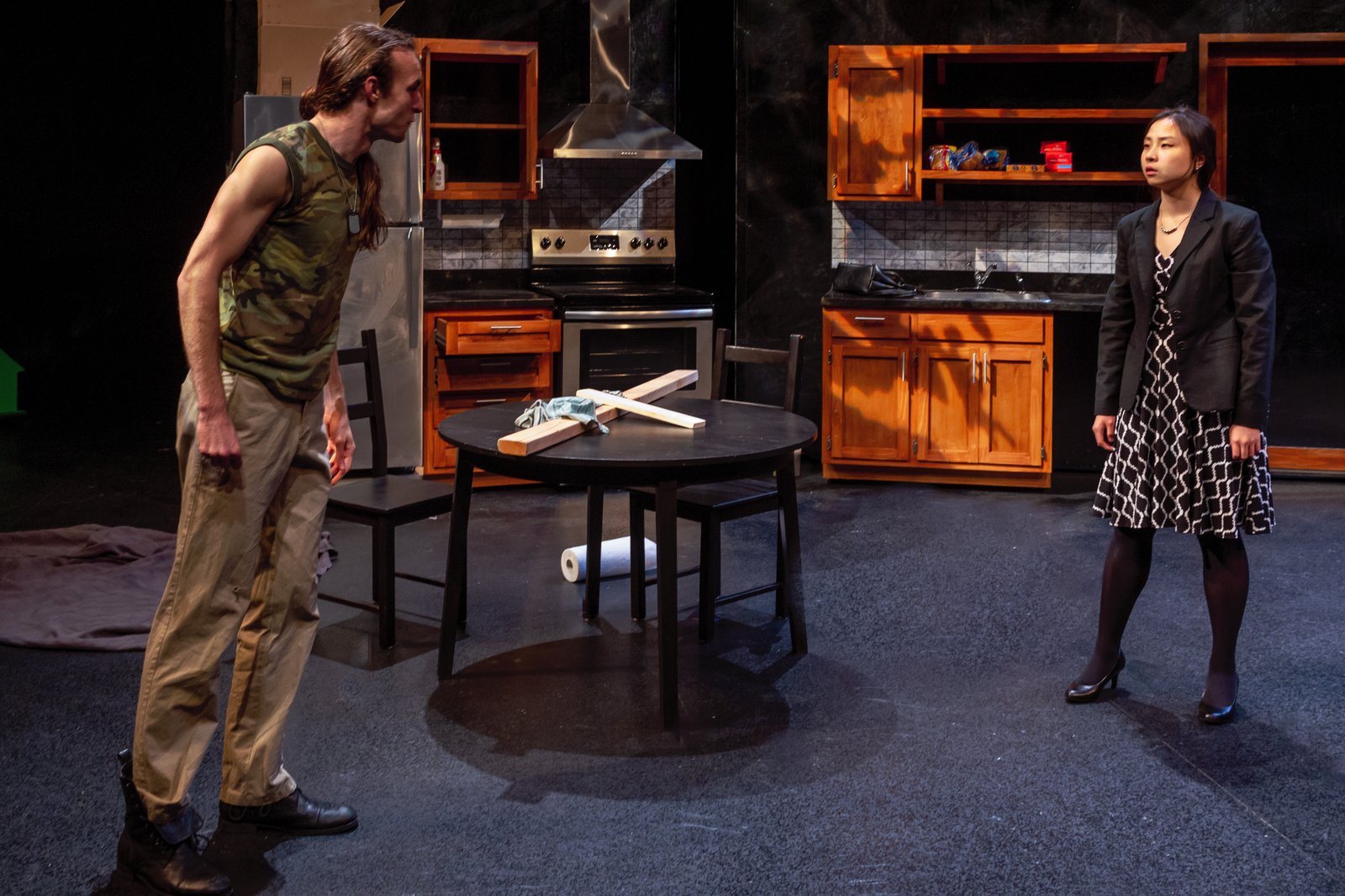 Production photo — the kitchen confrontation