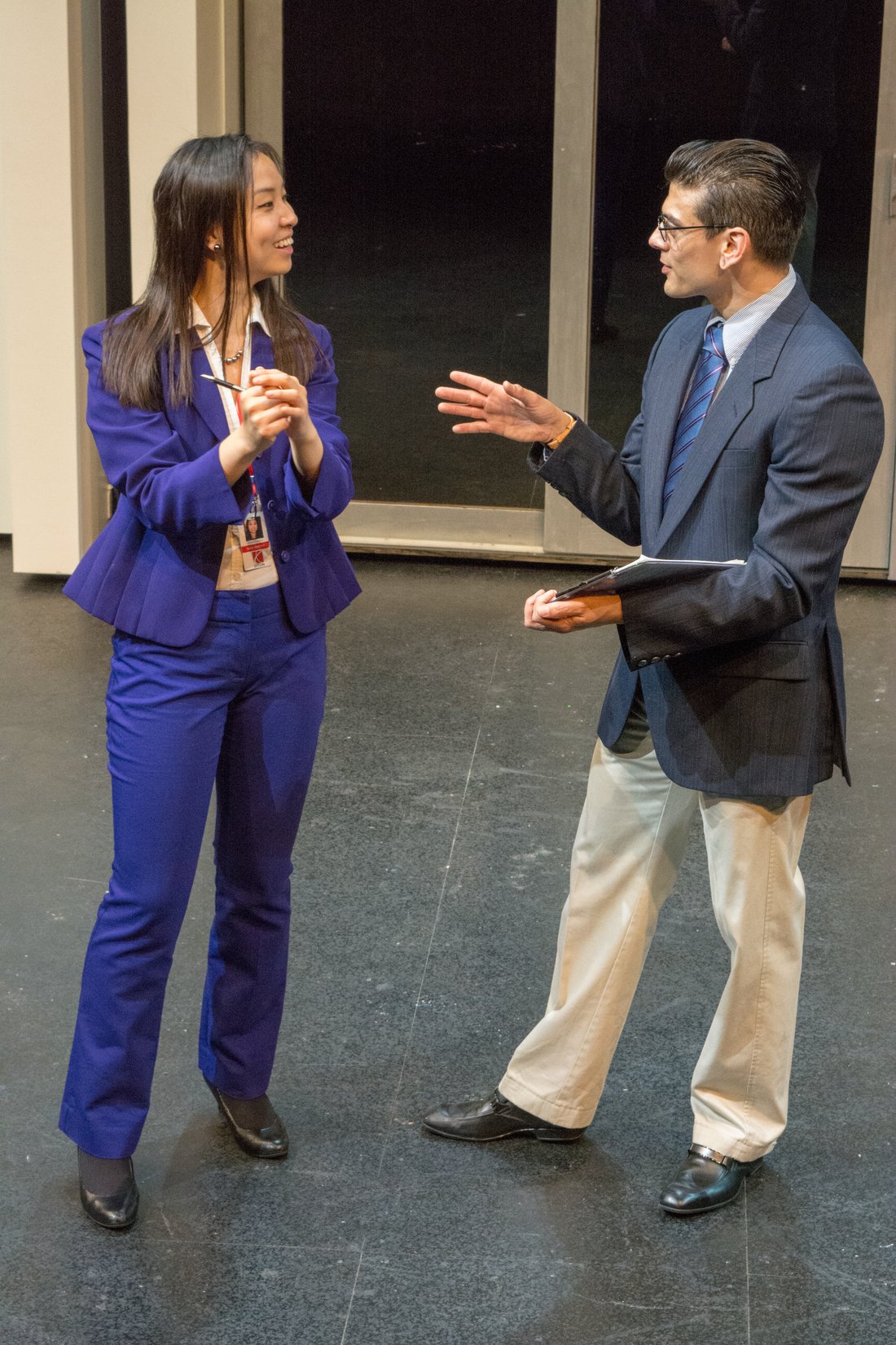 Production photo — two characters downstage