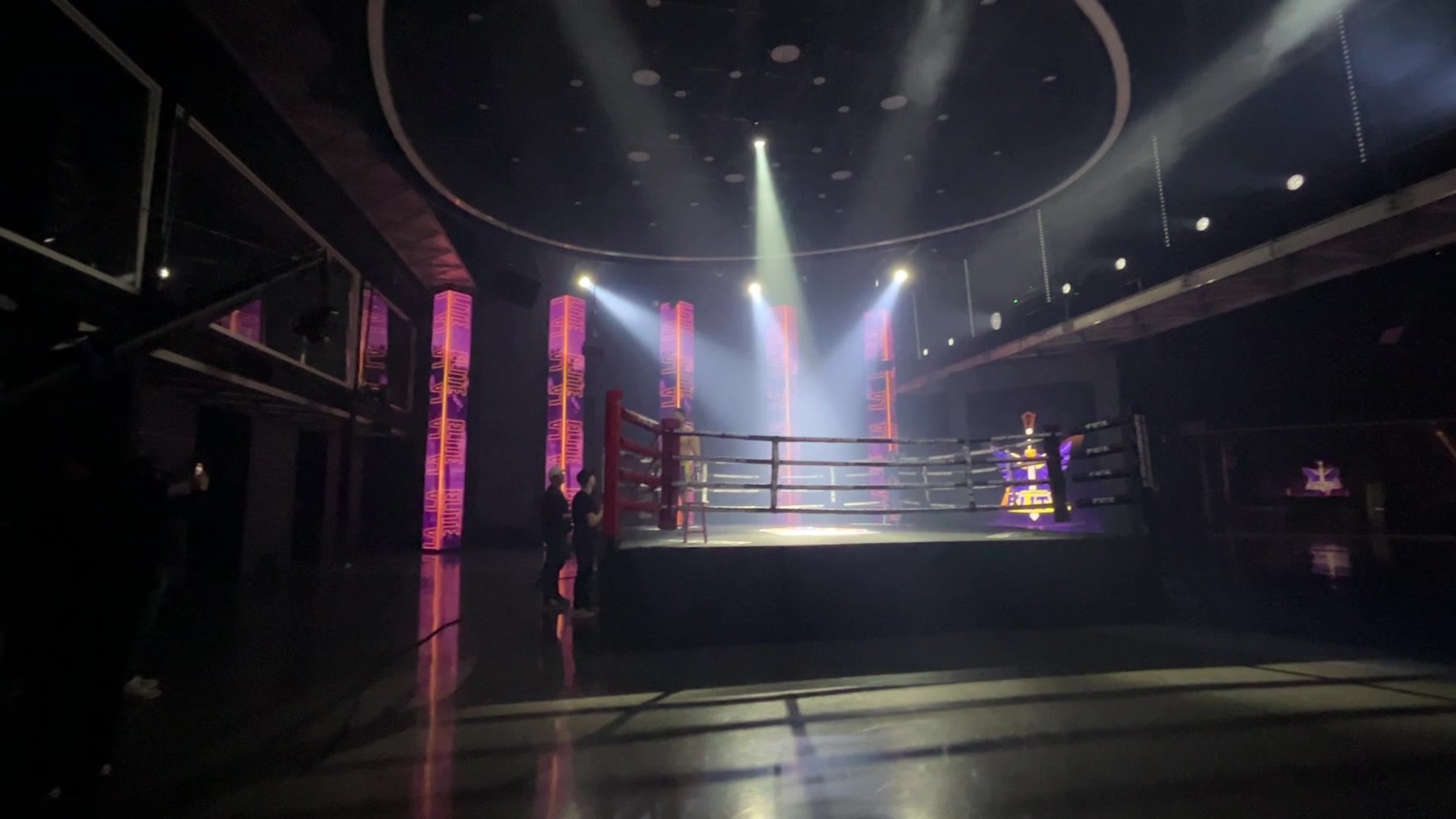 Team Boxing League — wide establishing shot of the ring in purple light