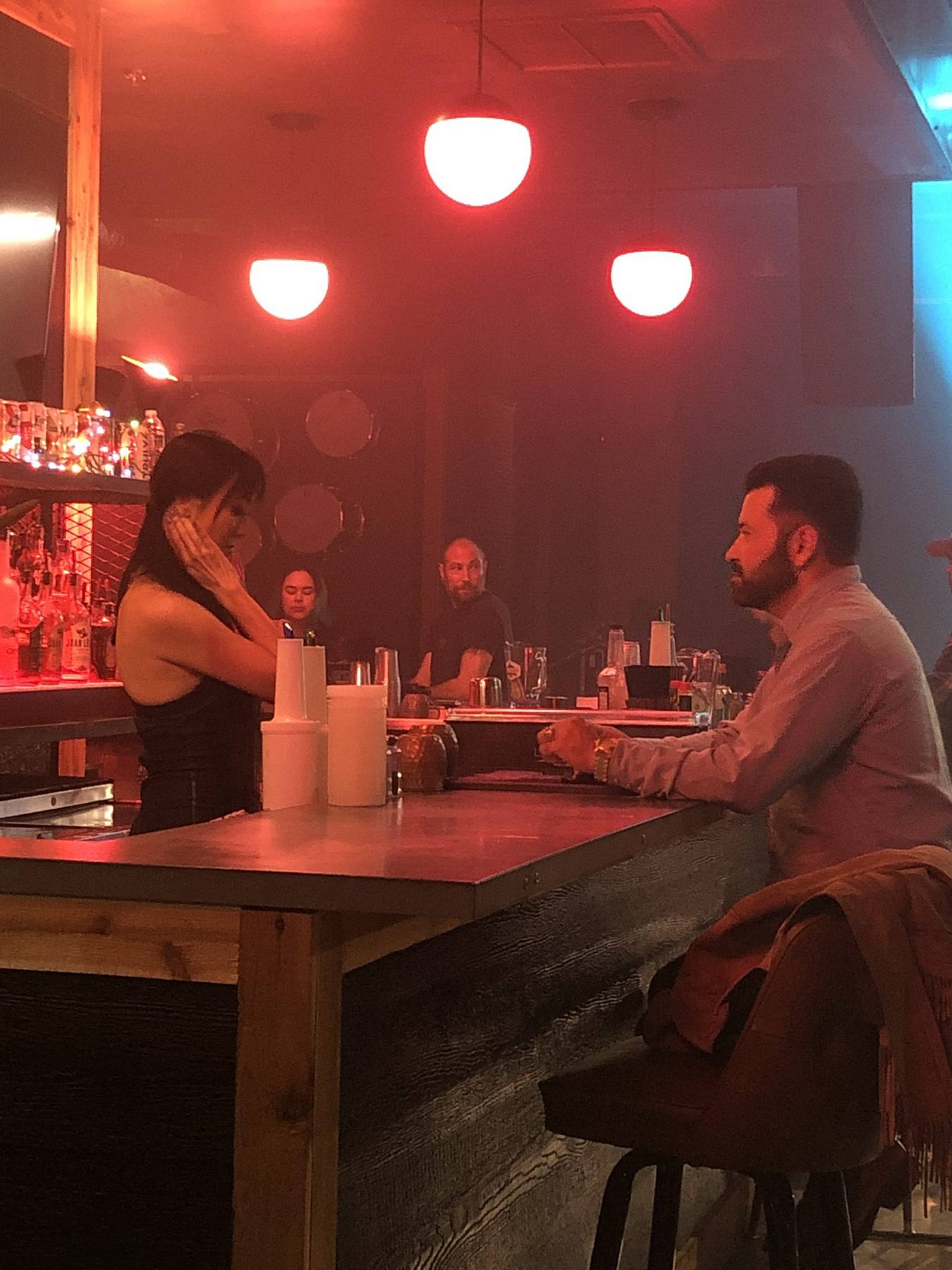 On set — styled band on stage, all-white wardrobe, production cameras