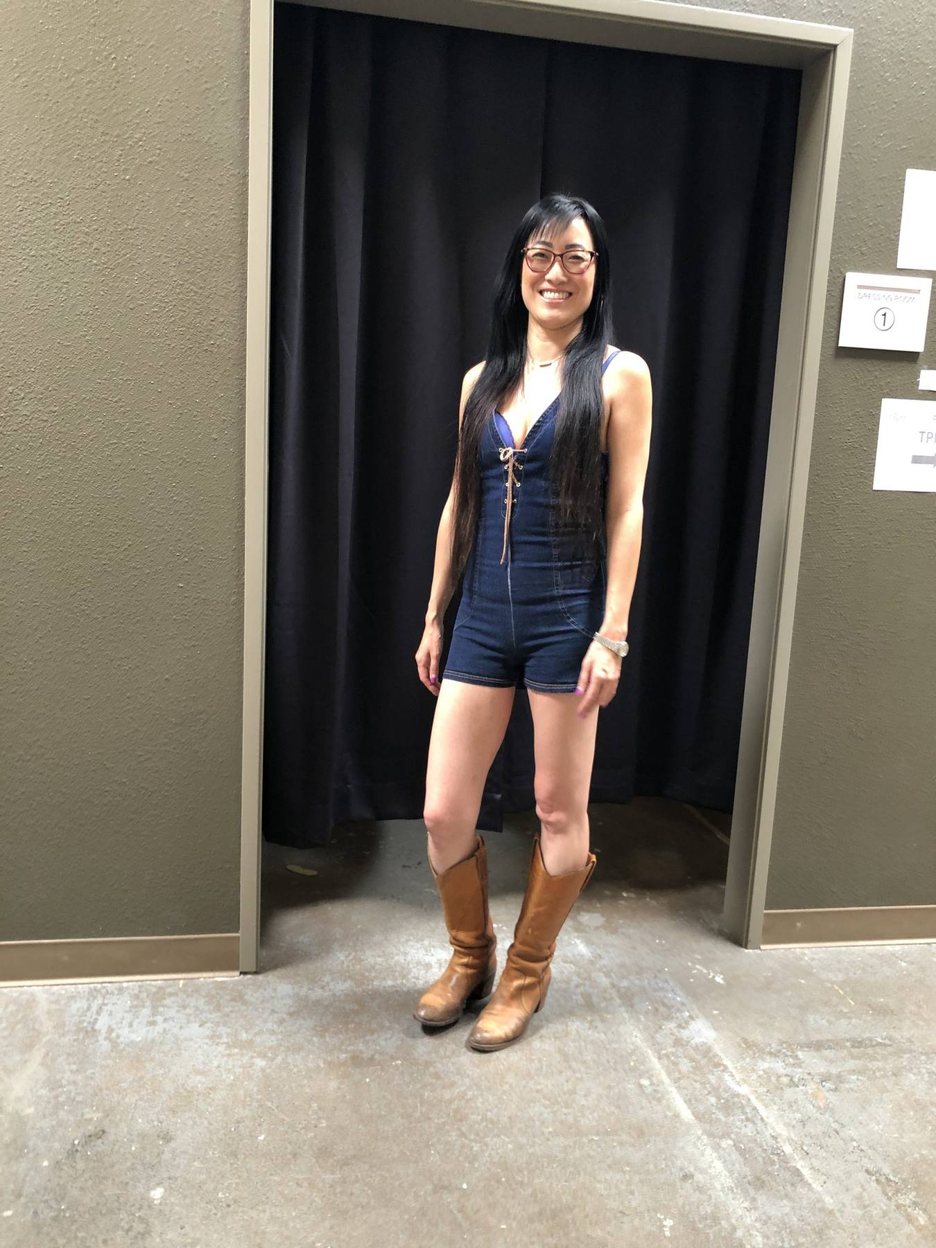Character fitting — denim lace-up romper and tall cowboy boots