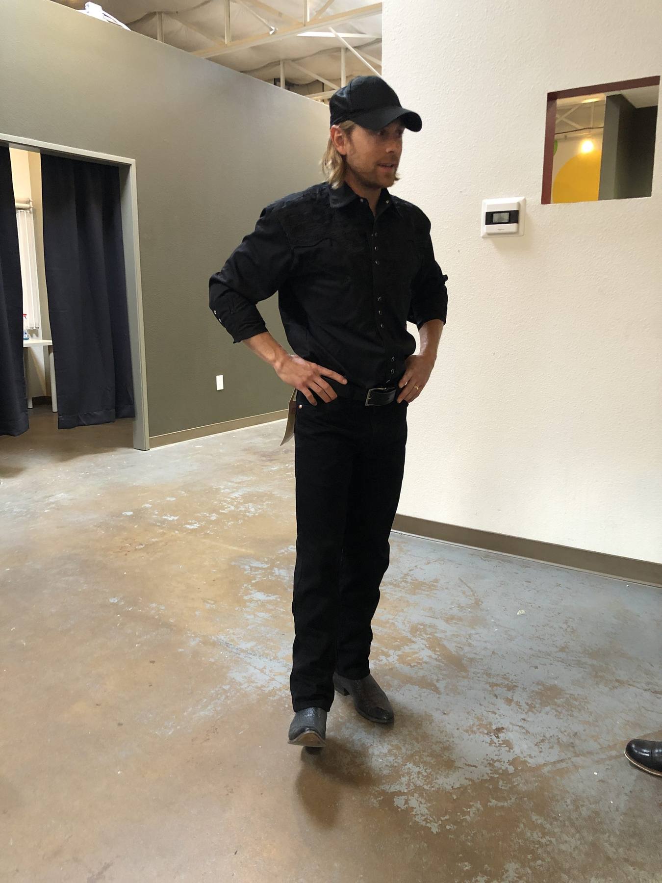 Character fitting — all-black western shirt with embossed yoke, black jeans and boots