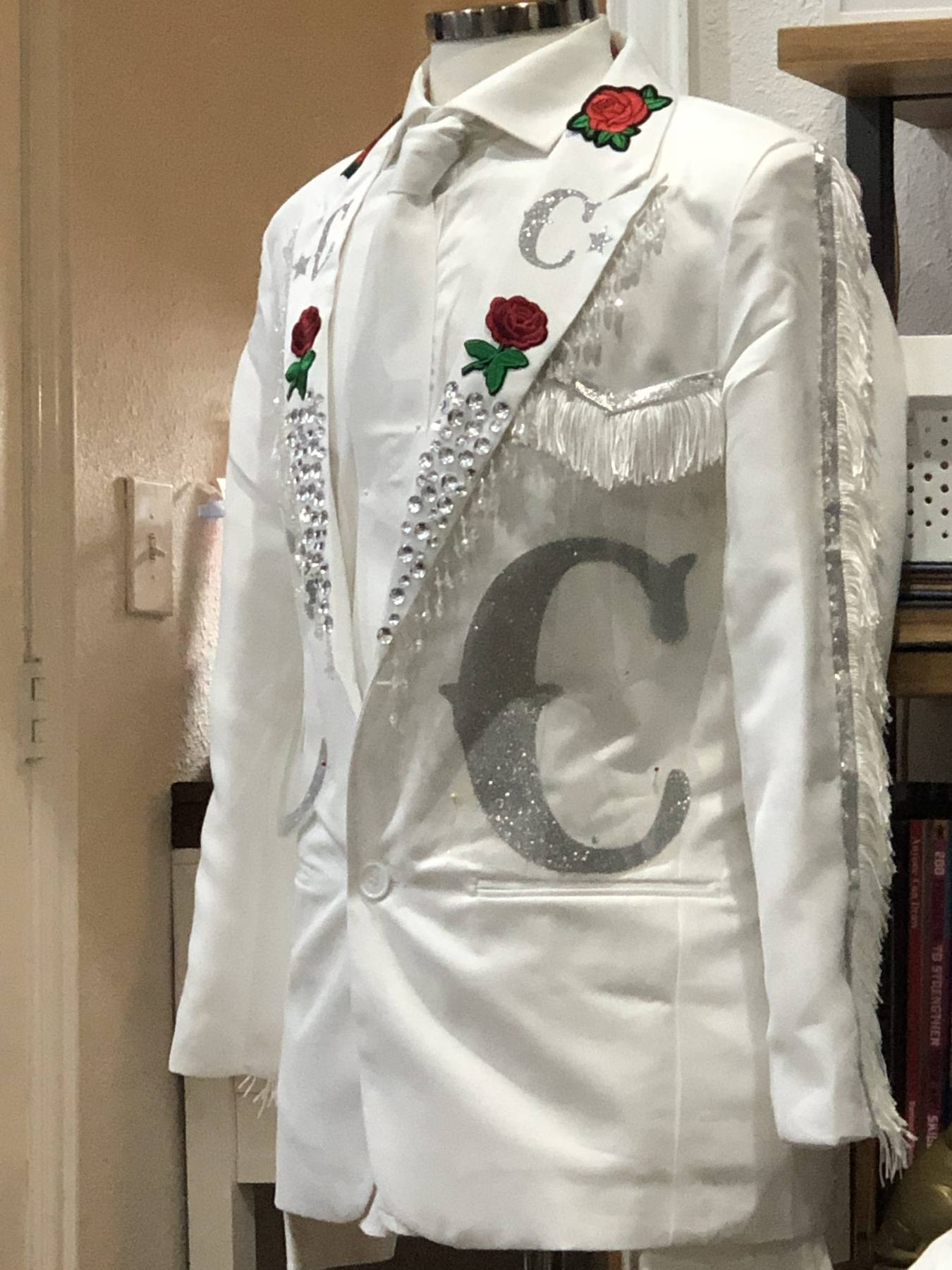 Hero costume — white blazer side view showing full fringe sleeve detail