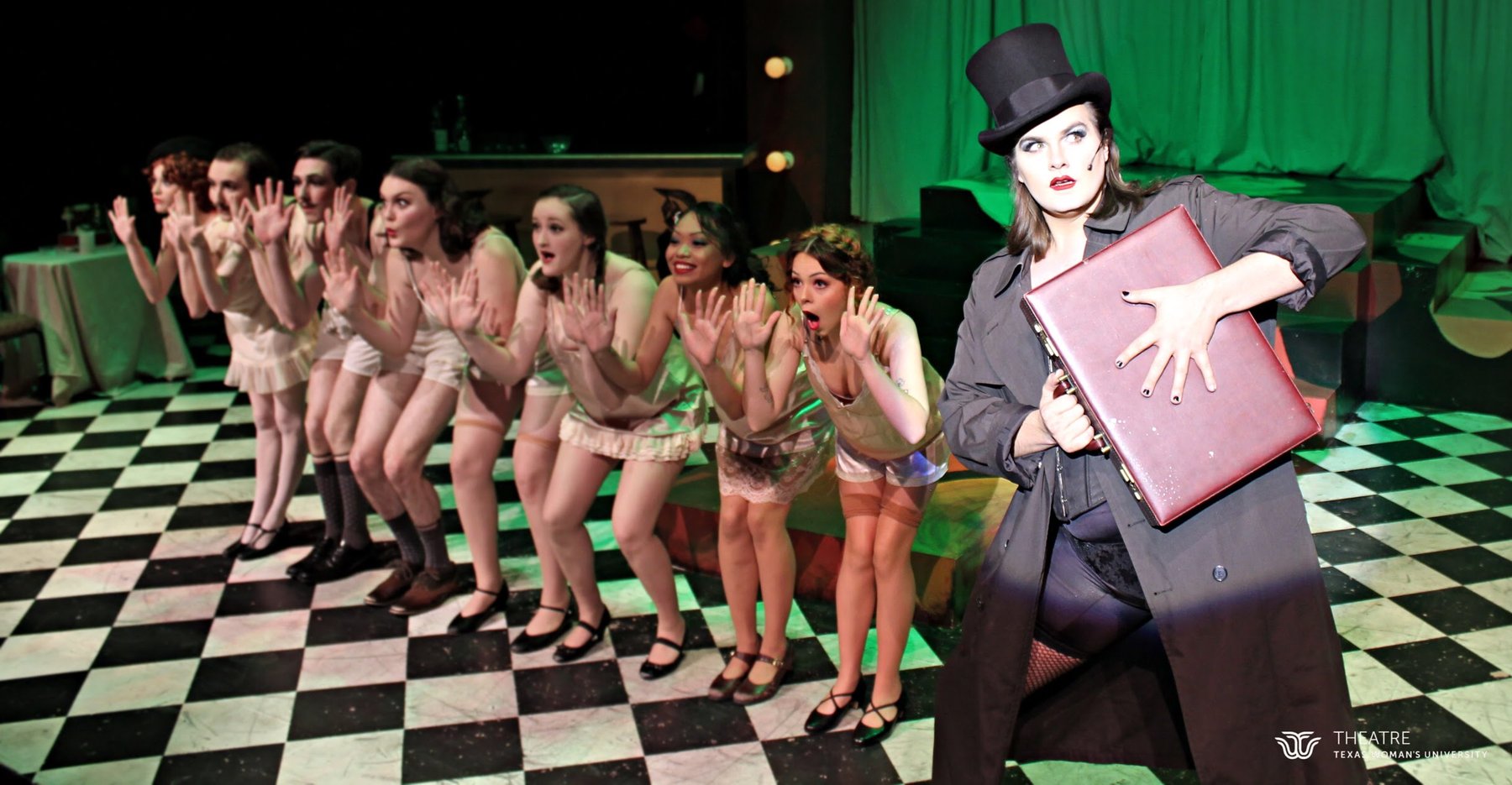 Cabaret — the Emcee with the company in a green-washed number