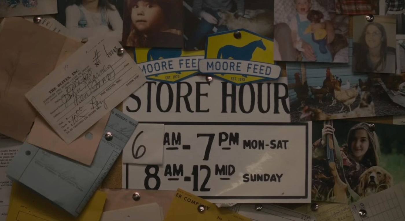 Store corkboard with Moore Feed hours sign and photos