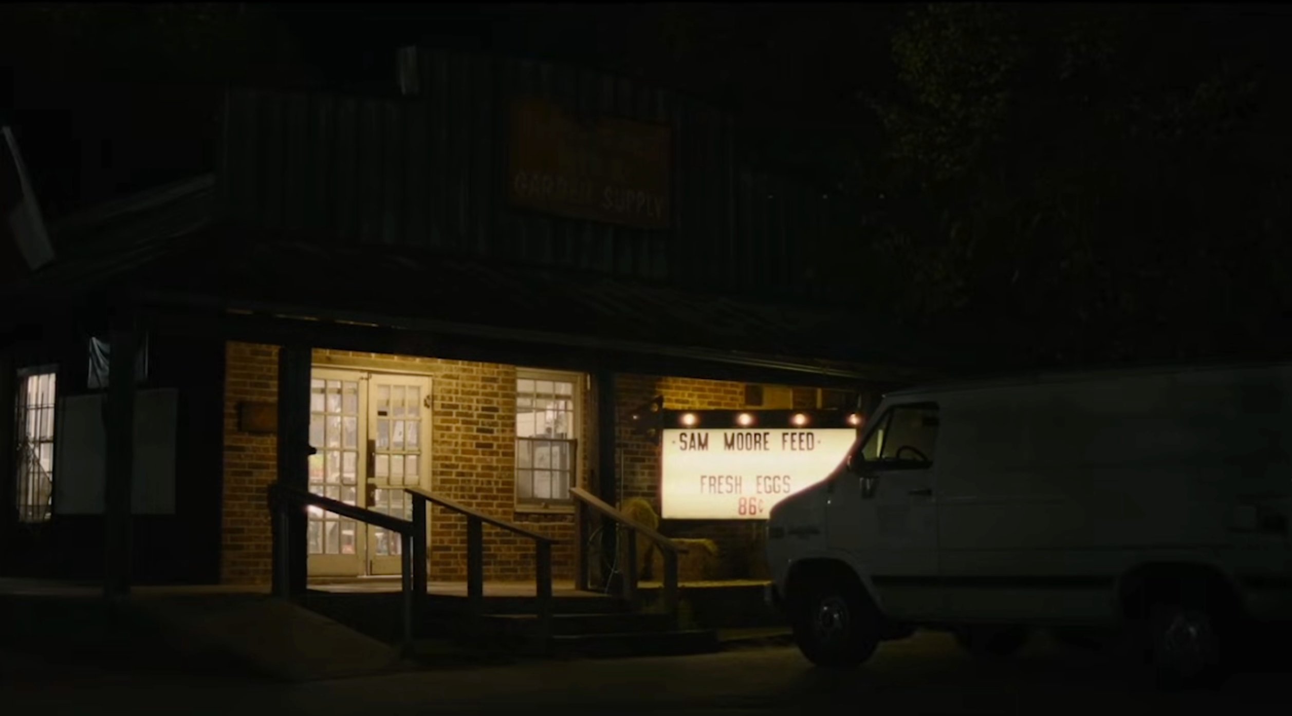 Sam Moore Feed store exterior at night