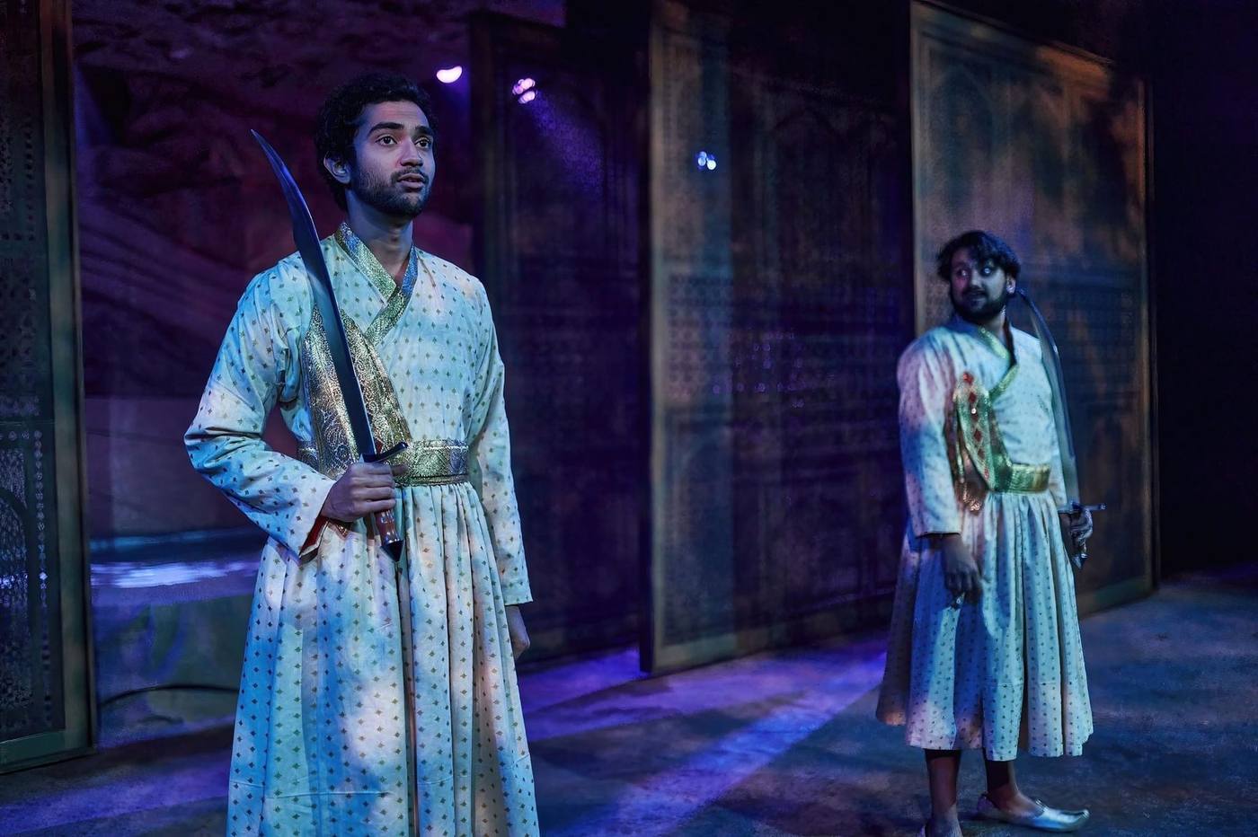 Both guards in blue light with lattice screens behind