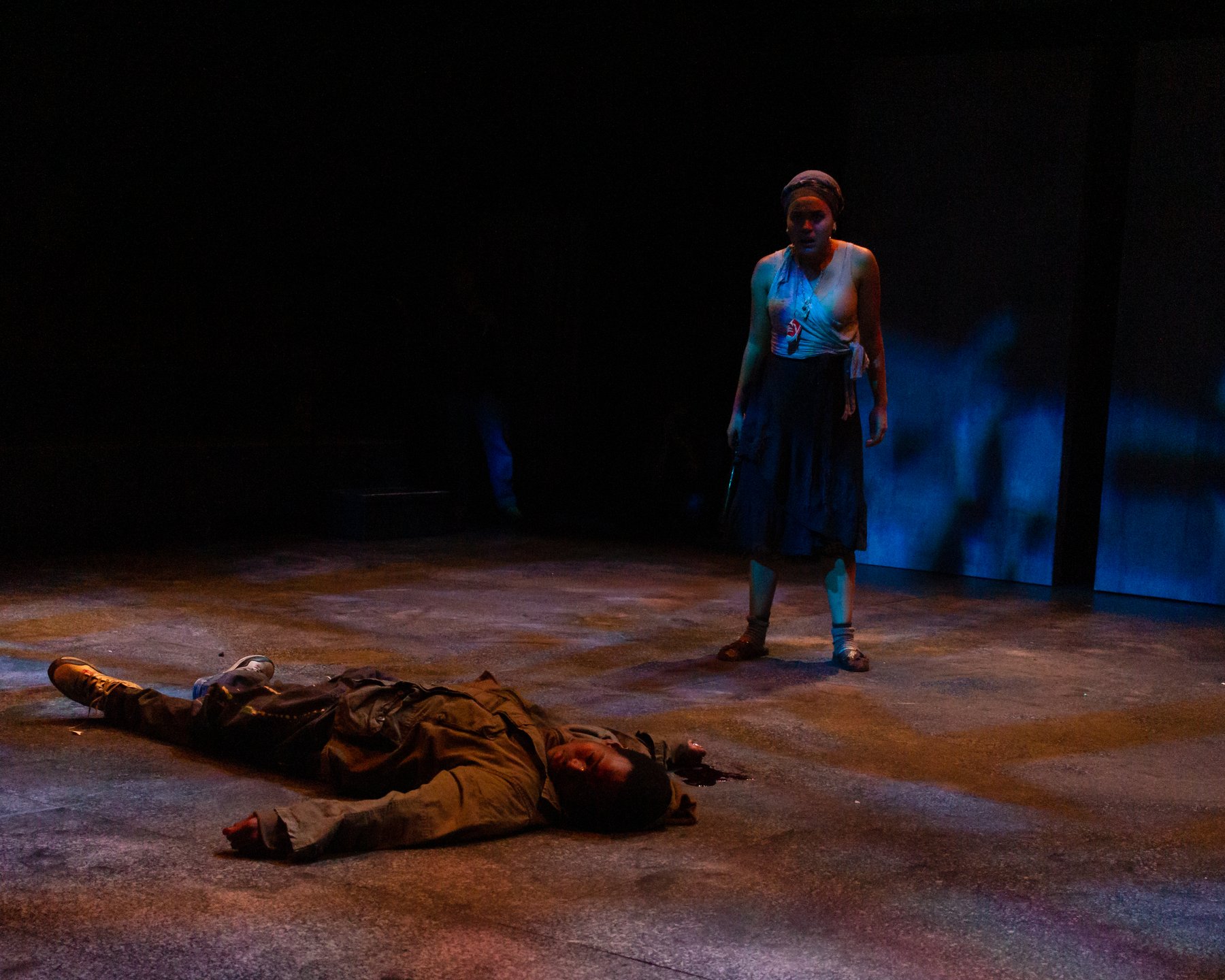 In the Blood — a figure under saturated red light