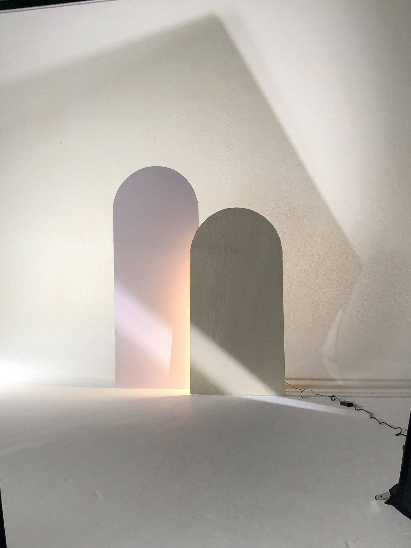 Behind the scenes — the cream and blush arch set pieces lit on the cyc
