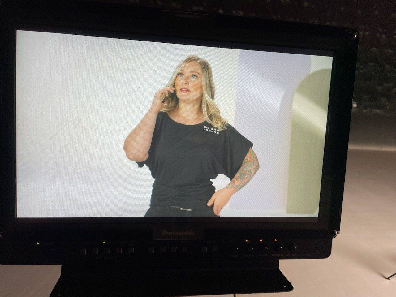 Behind the scenes — director's monitor showing a styled talent frame