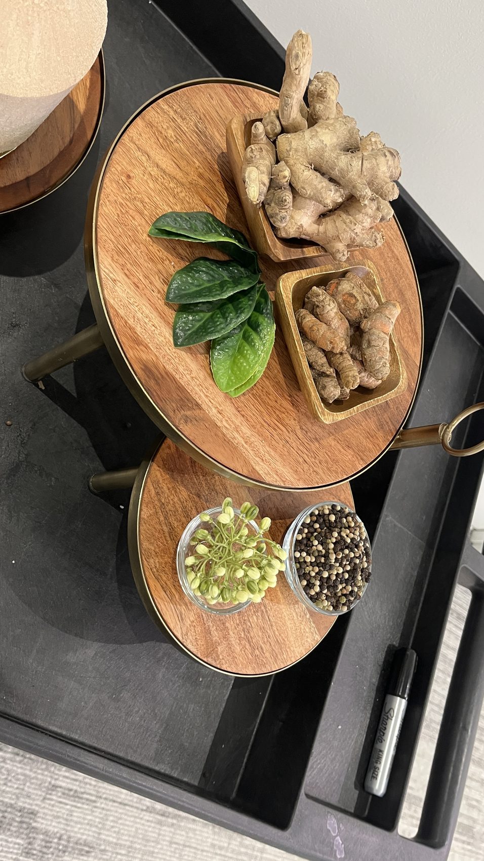 Styled tiered tray — turmeric, ginger, peppercorn