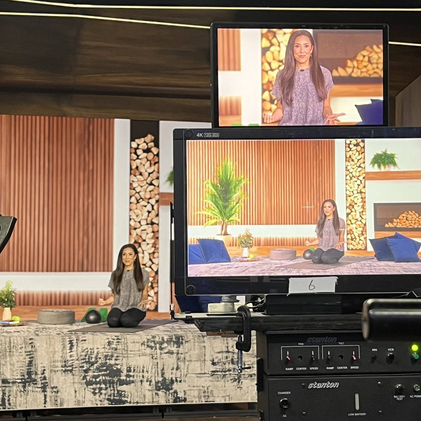 Behind the scenes — host on the styled wellness platform with the 4K monitor