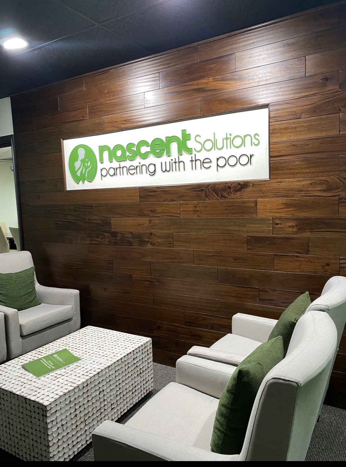 Nascent Solutions — reception wood wall with logo