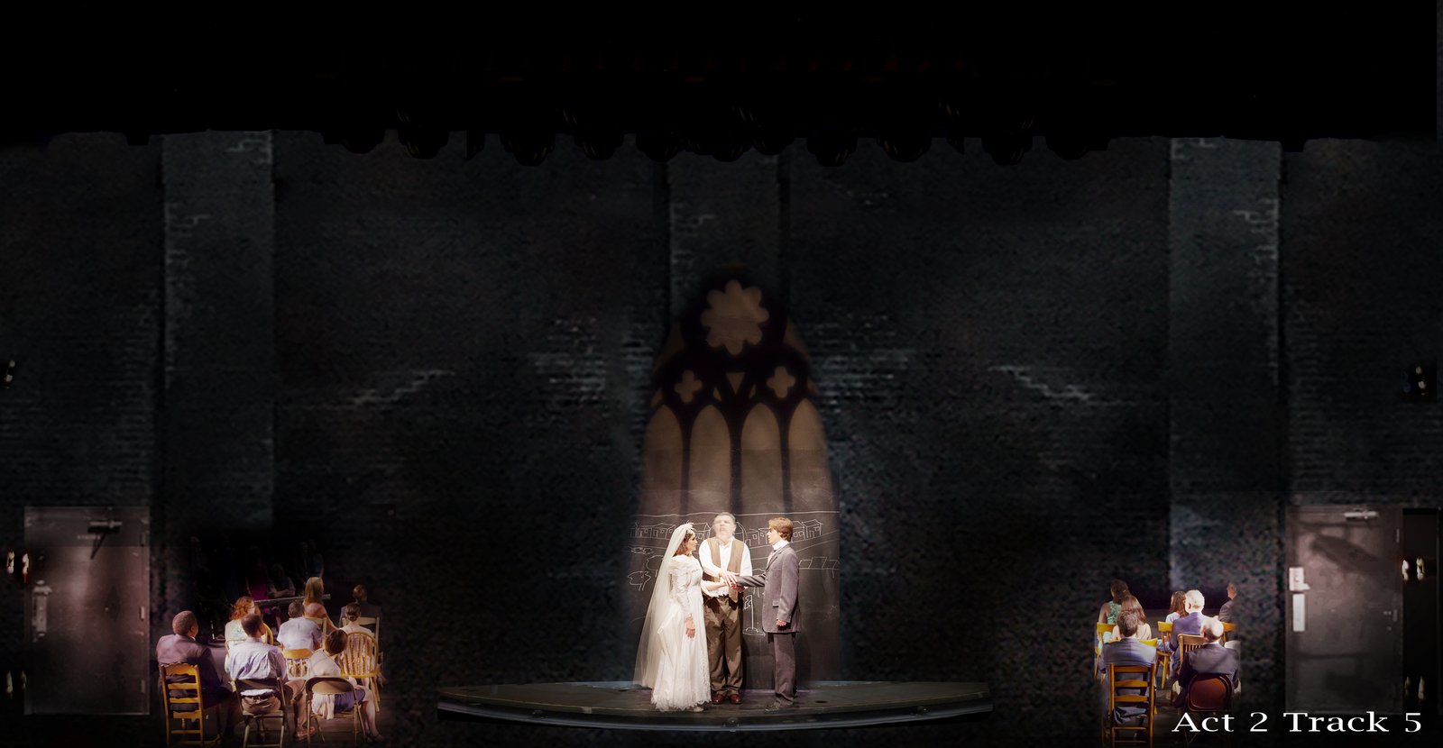 Act 2 — the wedding, the rose-window gobo thrown on the brick wall