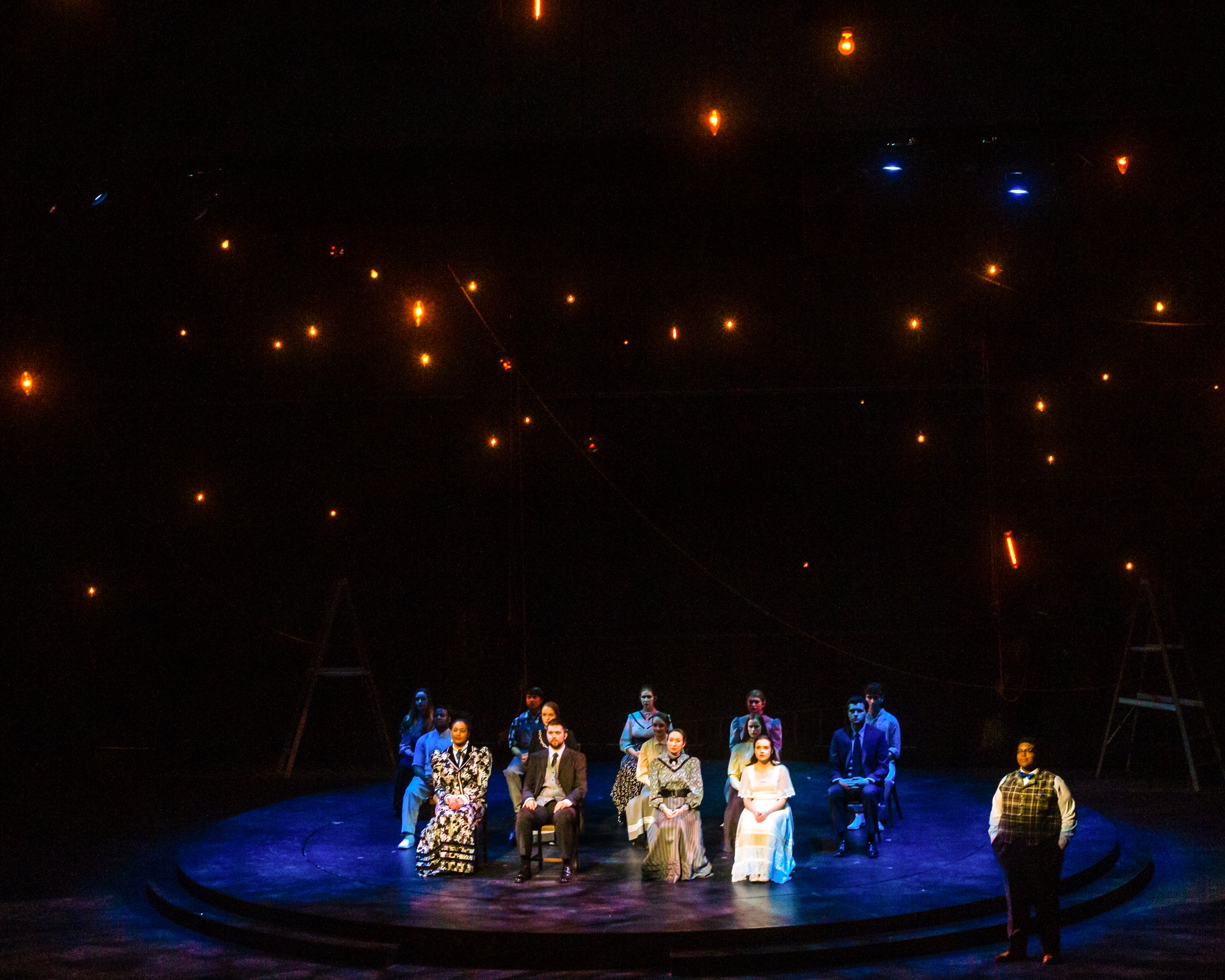 Production photo — the ensemble on the turntable under a field of stars