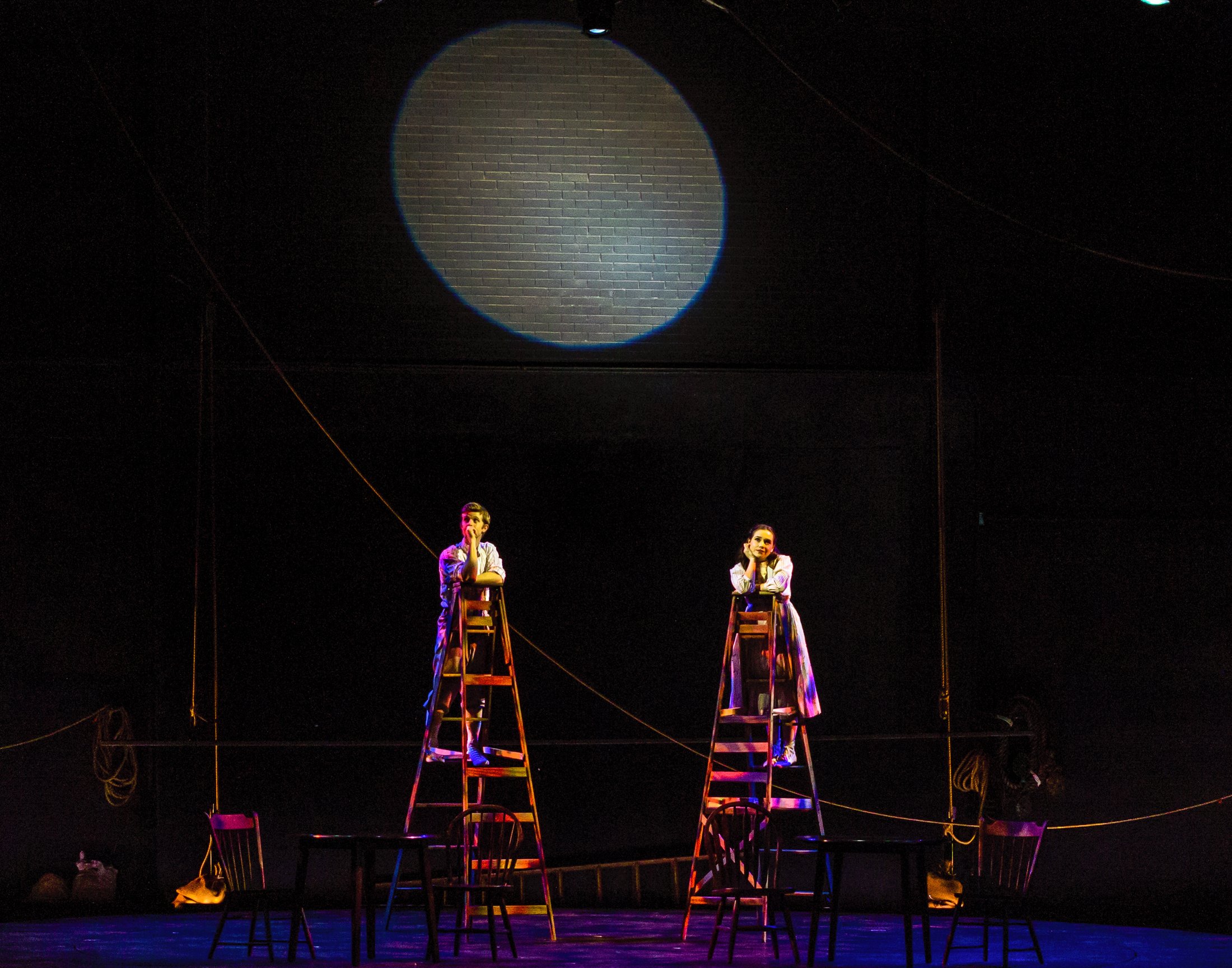 Production photo — the two ladders and moon, the turntable mid-rotation