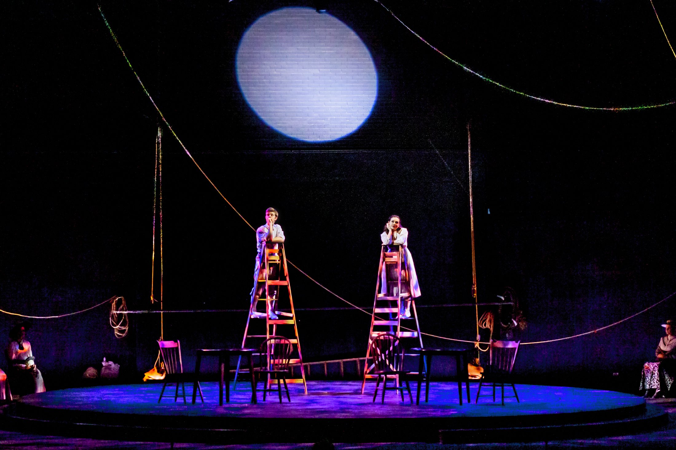 Production photo — the ladders in rich color light on the turntable