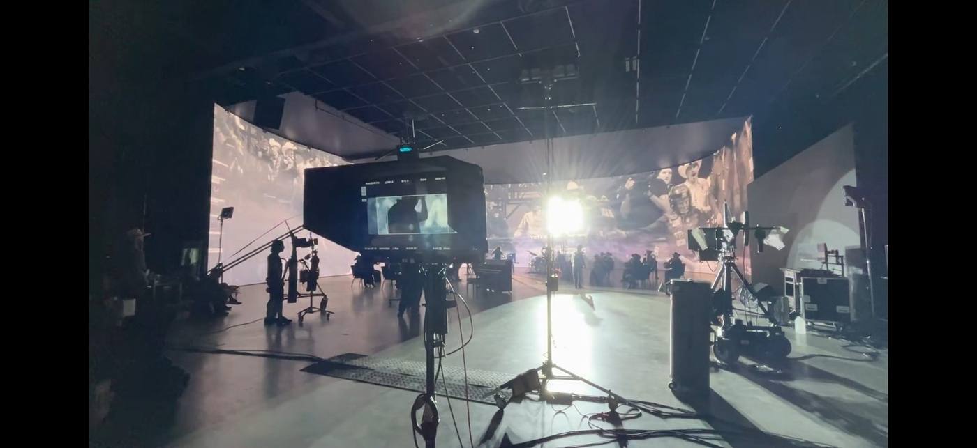 On set — director's monitor and the LED volume stage, performers in position