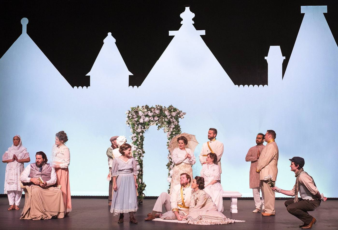 The Secret Garden — full-company finale tableau under the white gabled-rooftop cutout, Brick Road Theatre