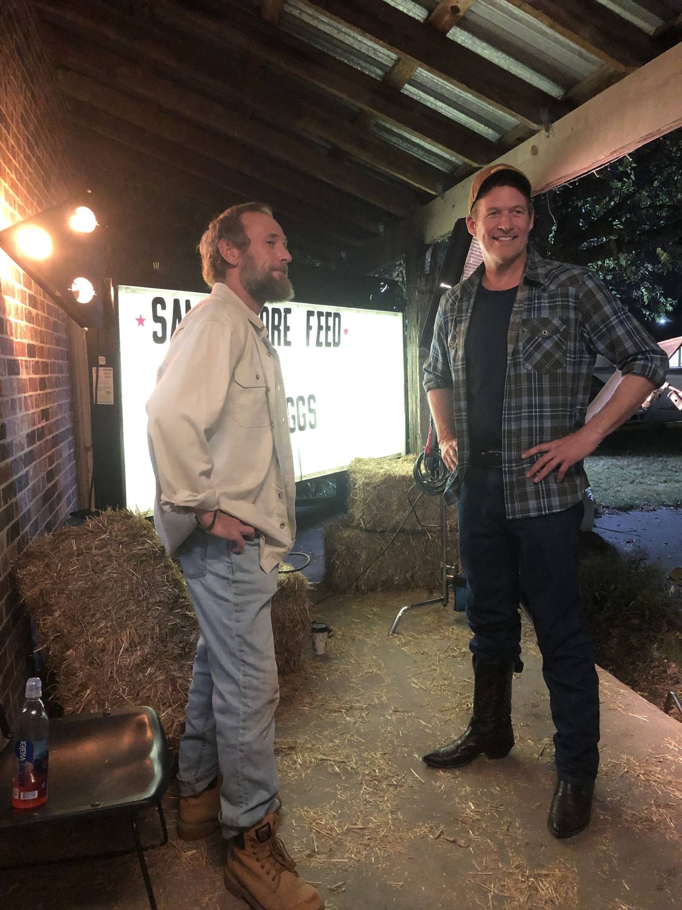 Actors between takes at the feed store exterior