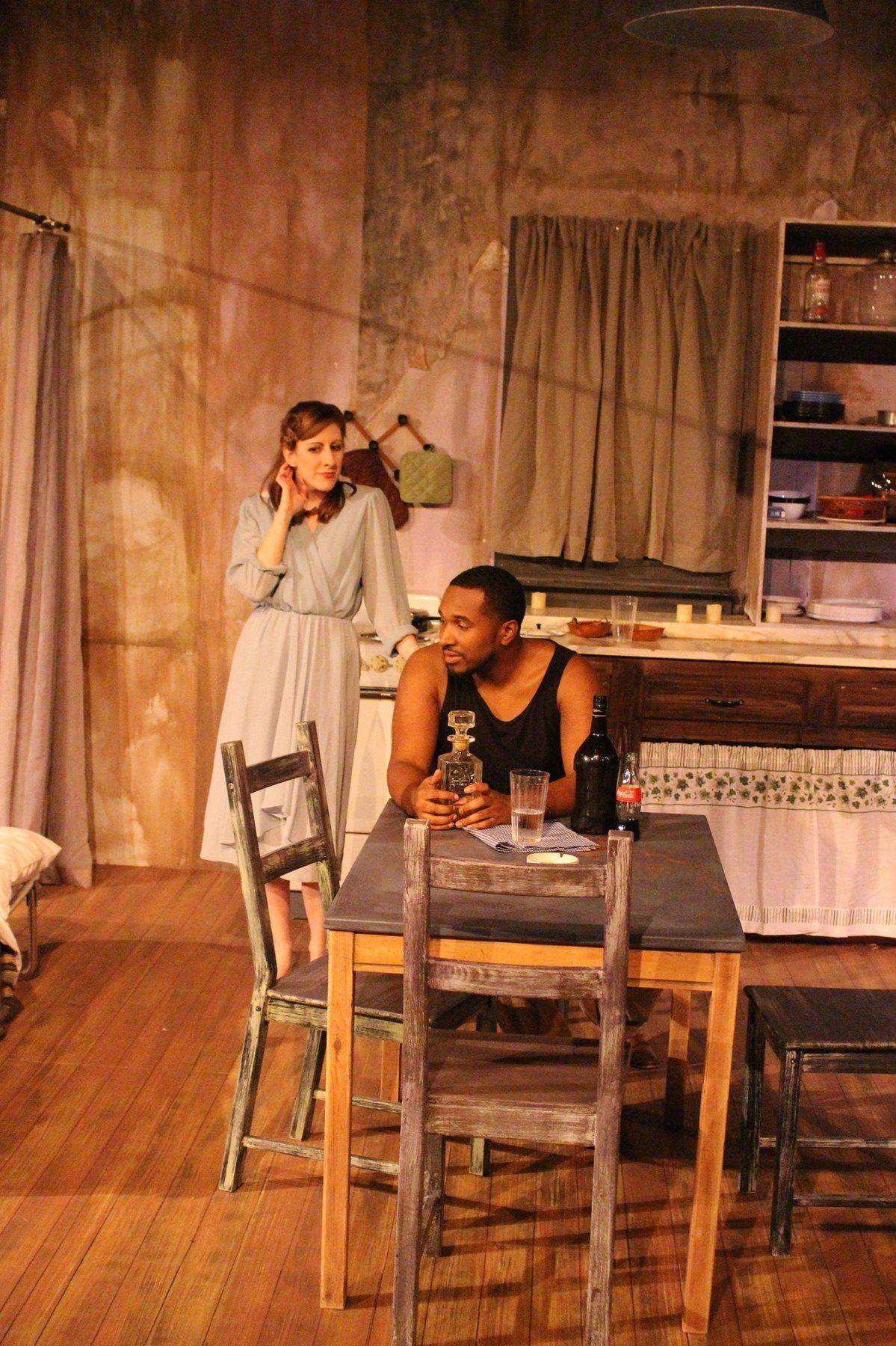 Production photograph — Stella and Stanley at the kitchen table