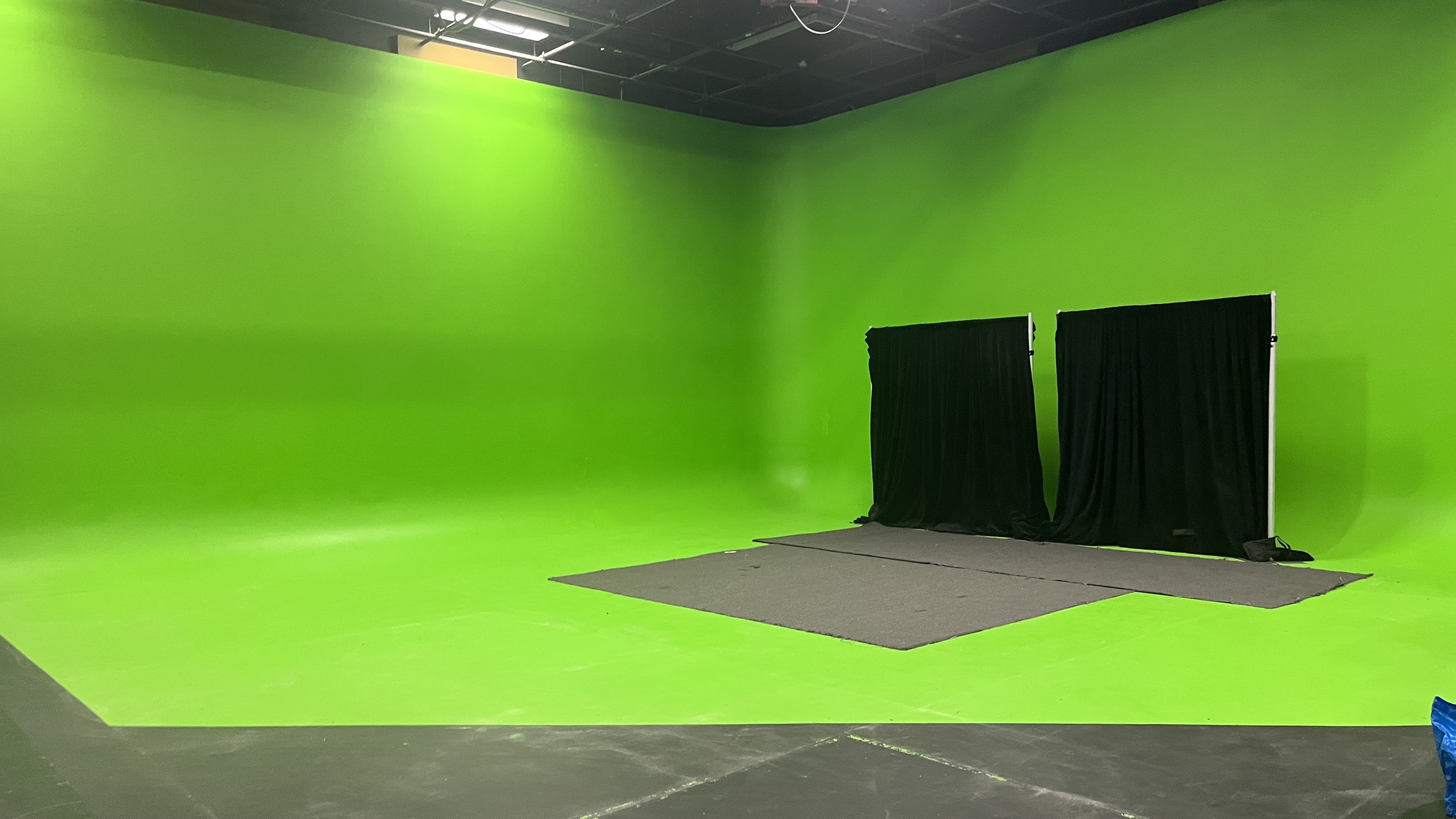 Before — empty green-screen studio cyclorama