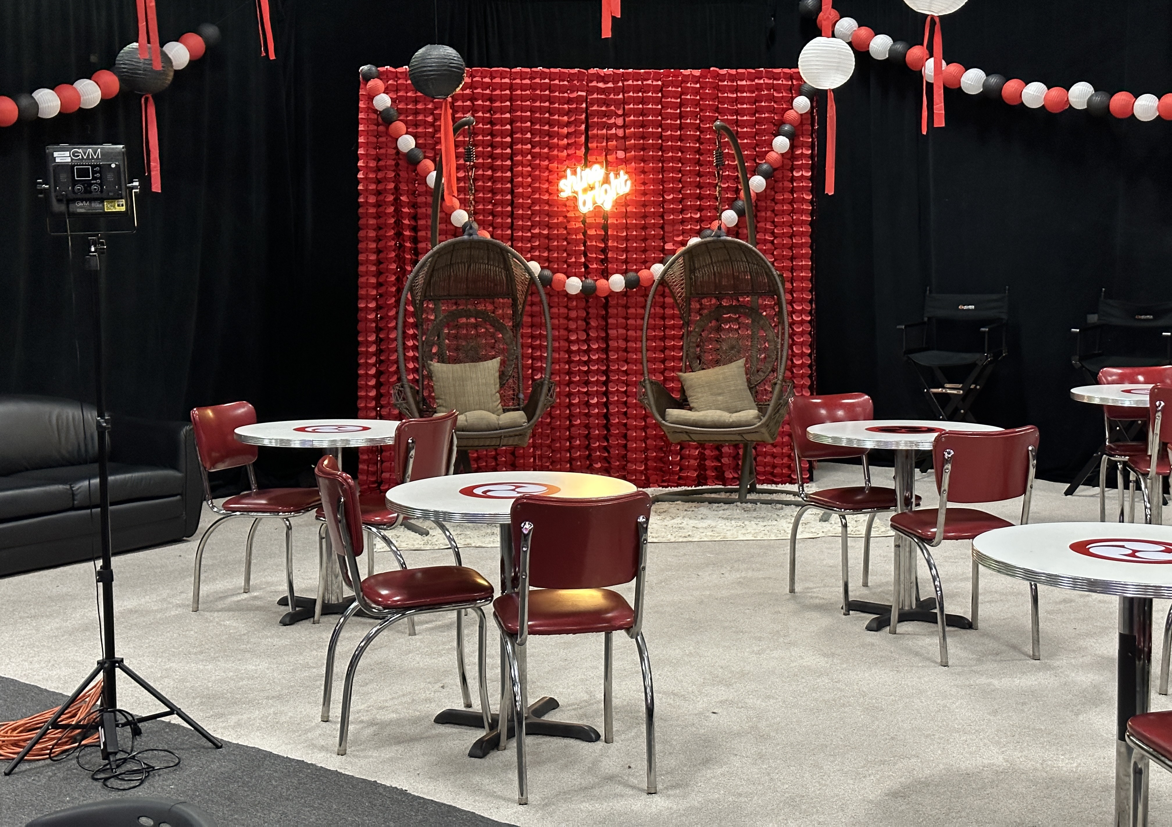 Topaz Film Festival — finished premiere lounge with café tables and the red photo wall