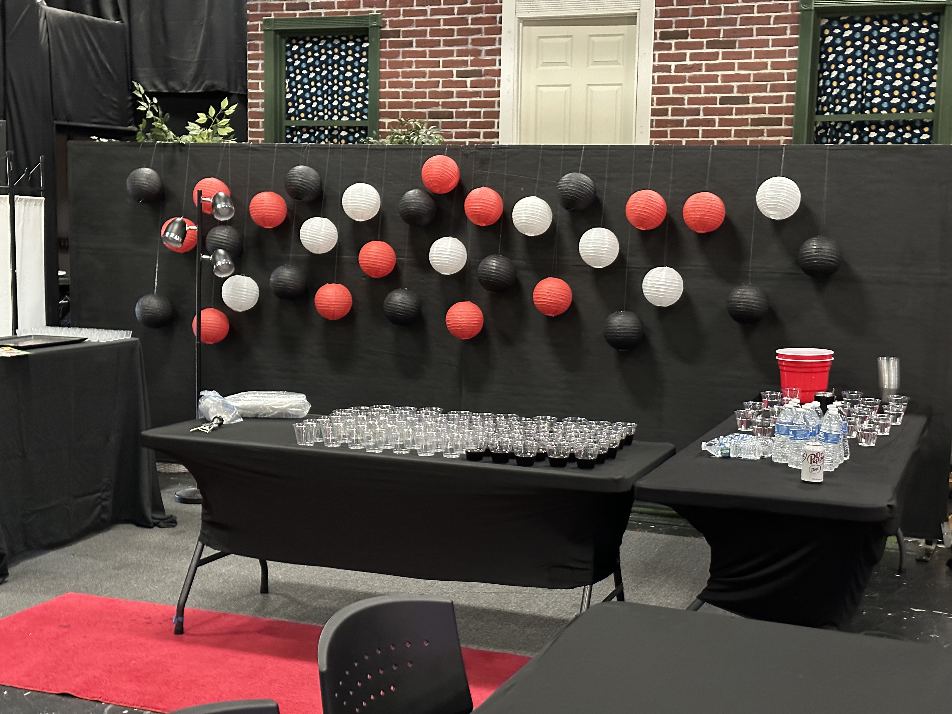 Black lantern feature wall behind the refreshment table and red carpet