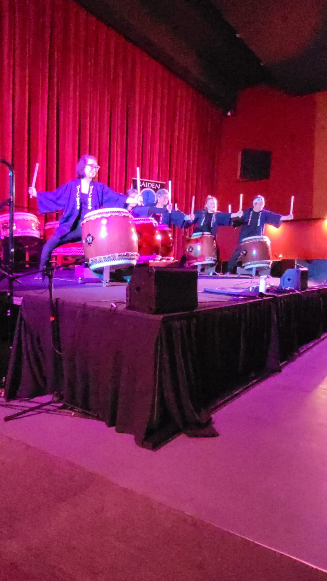 The full line of Taiko drummers, sticks raised
