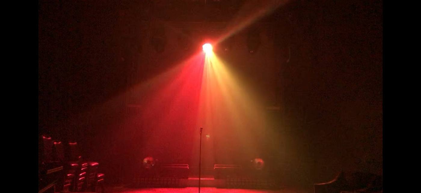 Vari-Lite Demo Room — single red-amber beam through haze