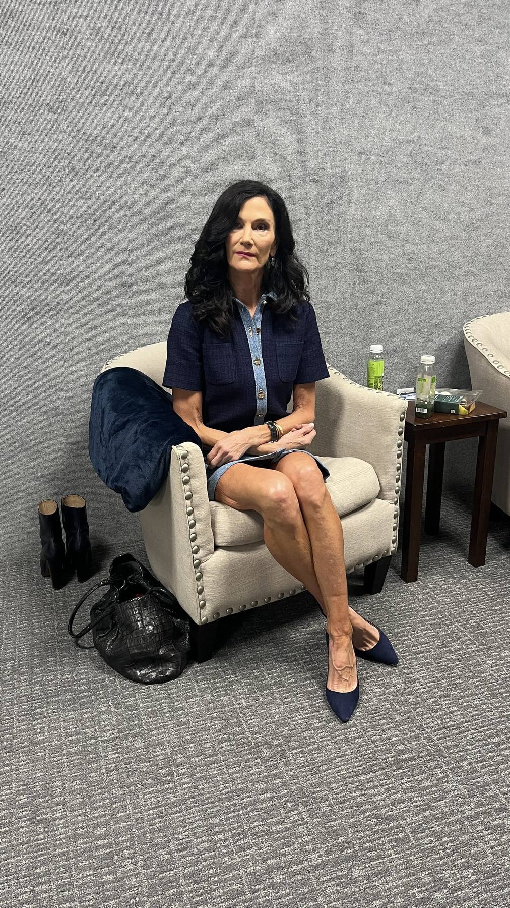 Guest waiting in navy denim short-sleeve dress