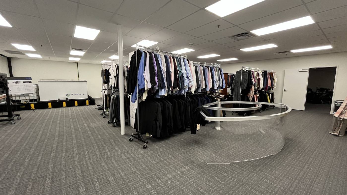 Wardrobe department — main room with clothing racks and circular display