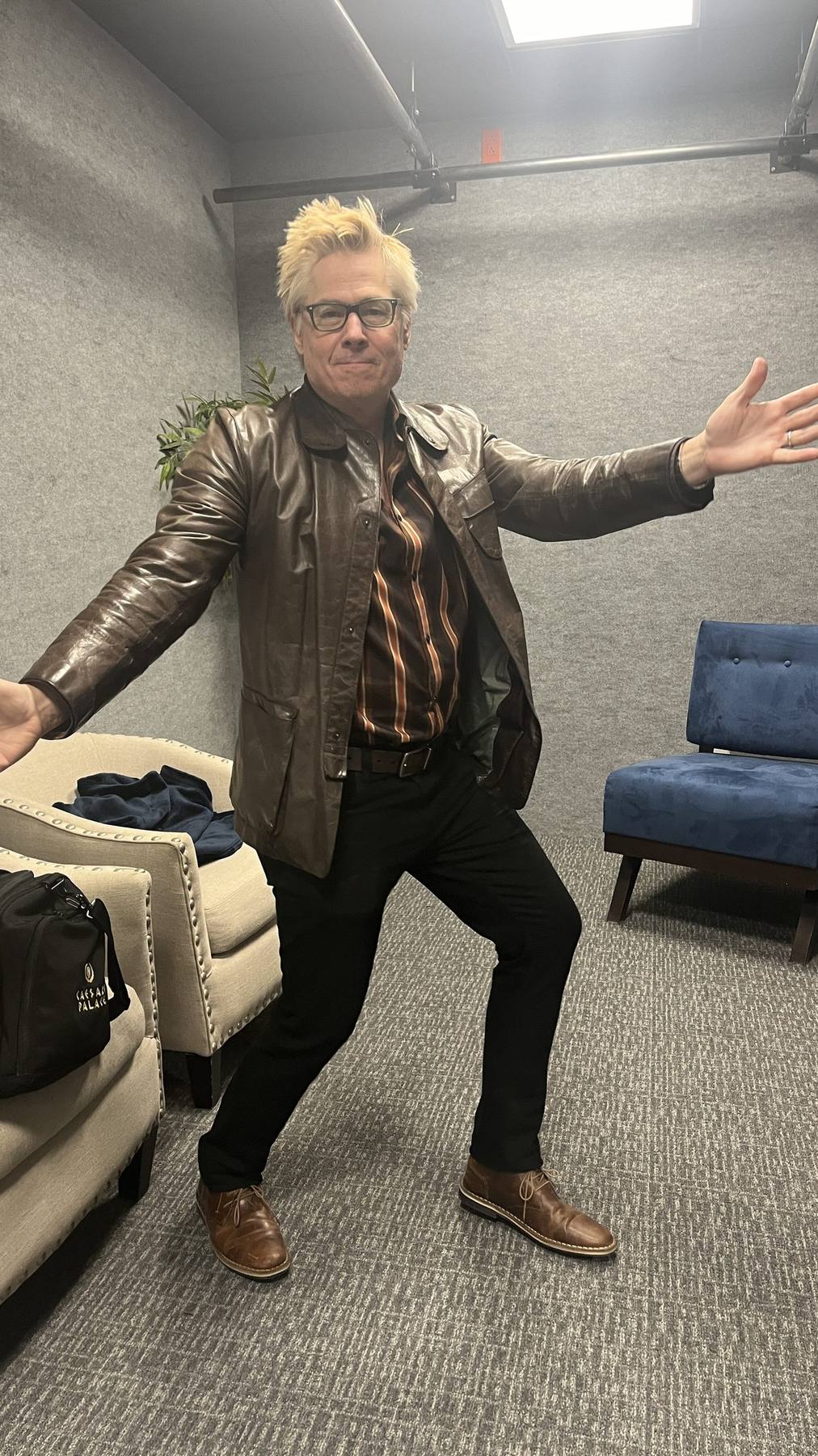 Guest fitting — brown leather jacket, striped shirt